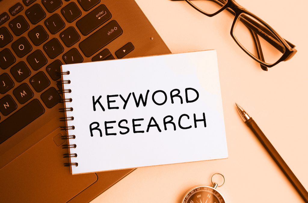 Free Keyword Tool Article Featured Image with Laptop, glasses, pen and compass