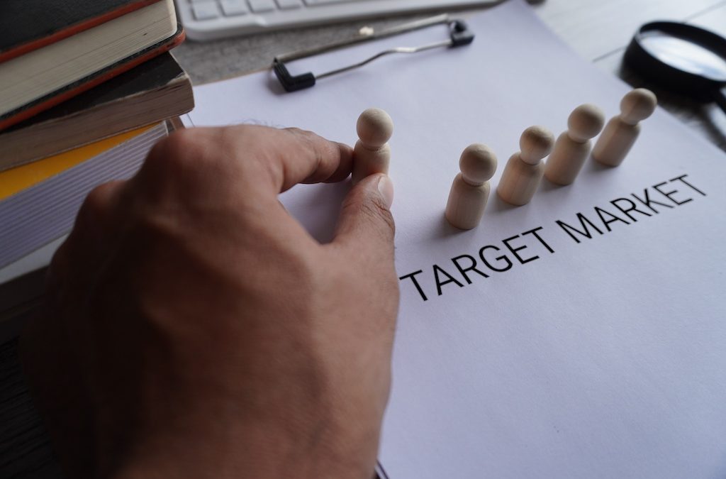 Defining your Marketing Goals Get Focused & Get Found eBook Chapter 5 Your Target Market with wooden dolls and text TARGET MARKET on paper clipboard