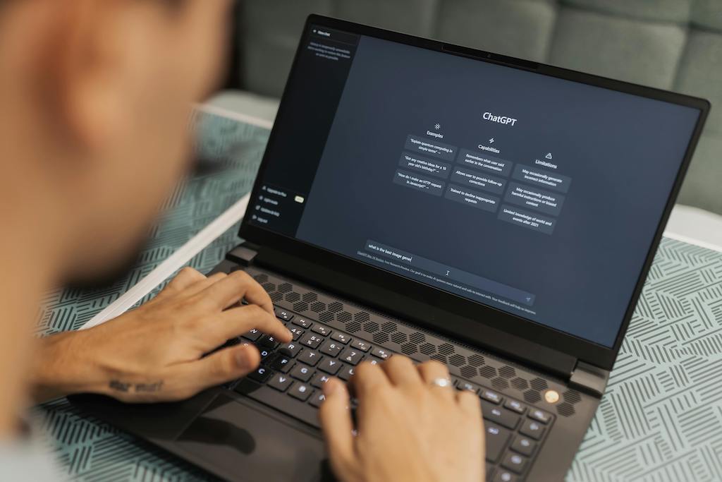 Man using ChatGPT on his laptop for his business