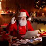 Happy JumpStart Matrix Santa on a video call waving to his fans on a laptop